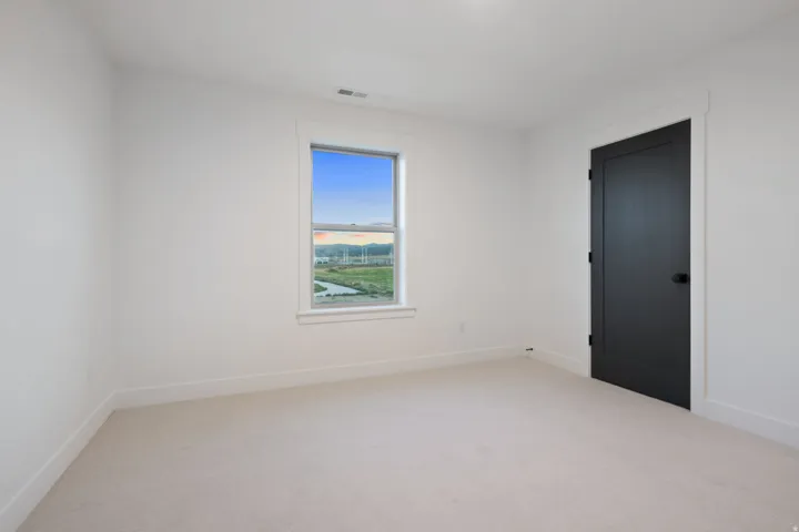 Neutral carpet flooring complements white walls