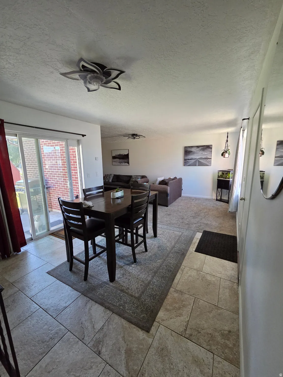 Expansive tiled flooring extending into a carpeted living area
