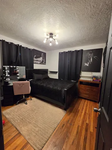 Wood-finish flooring with a flush-mount ceiling light fixture with plenty of light