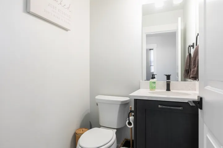 Vanity with a light-colored countertop, undermount sink, and matte black faucet