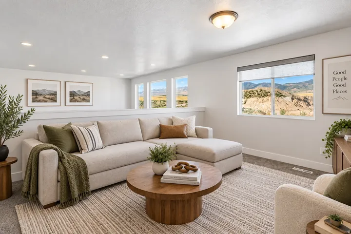 Recessed lighting, multiple windows, picture rail molding, and a partial open-concept wall with a wood-finish top