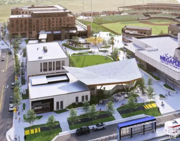 Large-scale development featuring multiple commercial structures, a green space, and an entertainment complex
