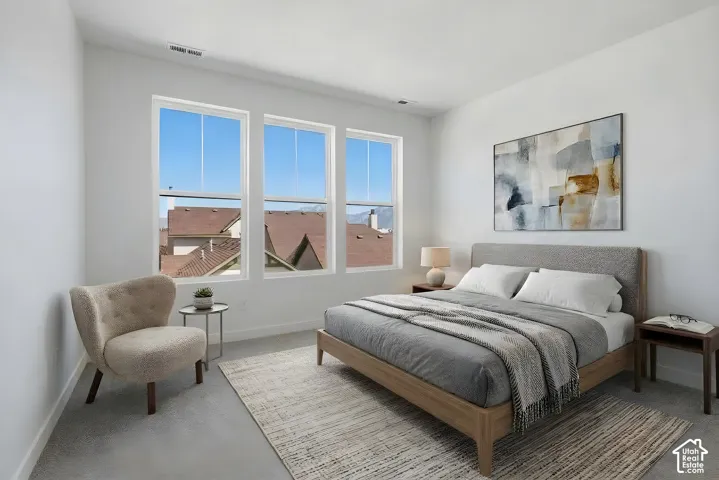 Triple paned windows, high ceilings, light-toned carpeting, and white wall finishes