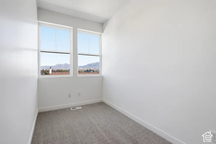 3rd level guest suite with large windows that showcase an amazing views of the Wasatch Mountains. Upgraded carpeted flooring, two pane windows, and 9 foot high ceilings