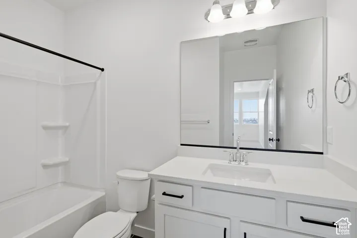 Counter height vanity with upgraeded quartz countertops, integrated sink, polished chrome faucet, and black hardware