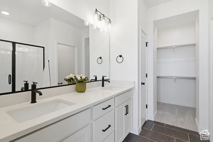 Dual vanity with integrated sinks, matte black fixtures, and white cabinetry