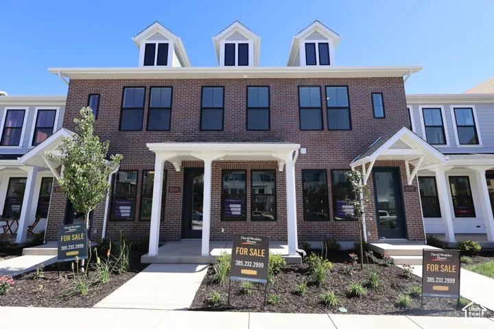 Brick exterior with dormer windows and black-framed windows