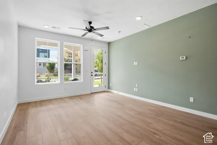 Wood-finish flooring, recessed lighting, and a ceiling fan