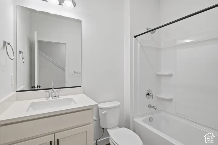 White vanity with an integrated rectangular sink and chrome faucet