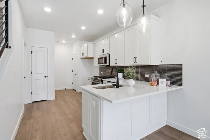 Kitchen featuring upgraded cabinetry, stainless steel appliances, upgraded tile backsplash,upgreaded quartz countertops with composite undermount sink