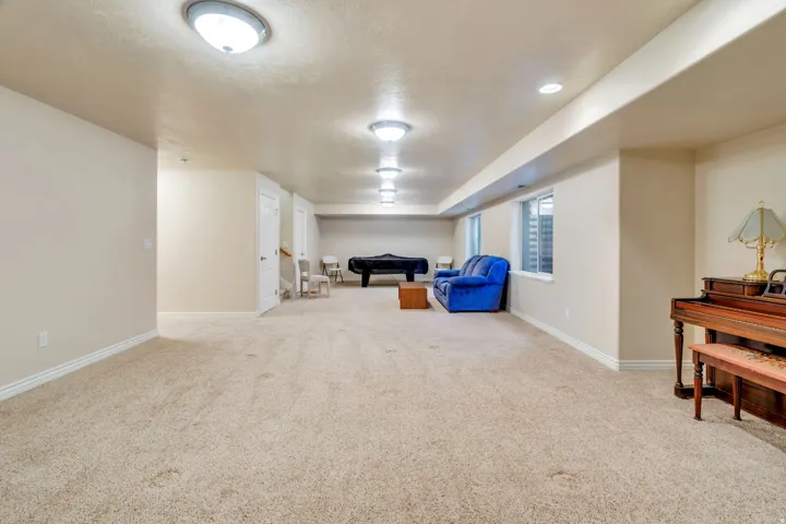 Spacious carpeted room featuring recessed lighting, a built-in window, and white trim