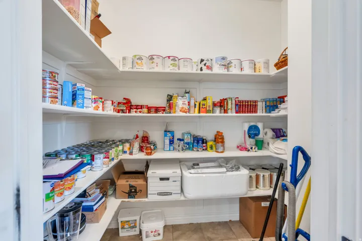 Walk-in pantry featuring extensive built-in shelving