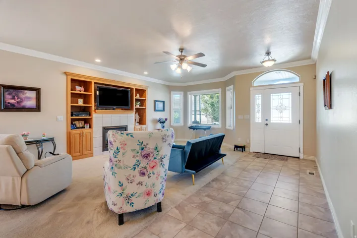 Tile flooring entry with a decorative dual-pane front door and transom window