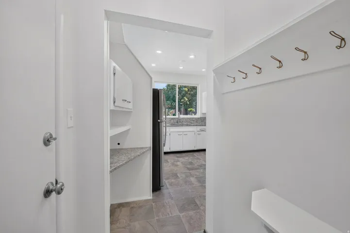 Entryway with built-in coat rack and integrated shelf