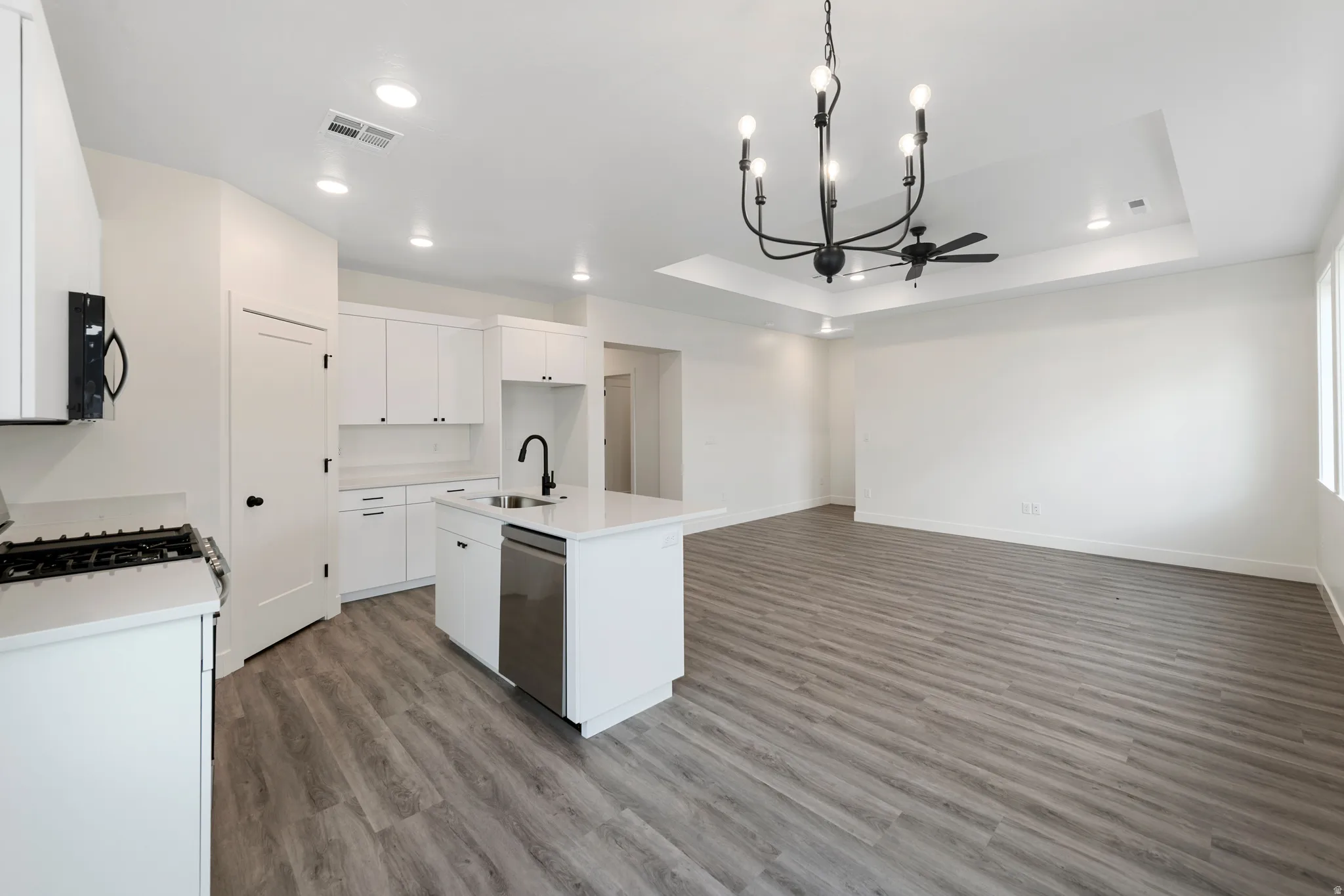 Open-concept living space with wood-finish flooring