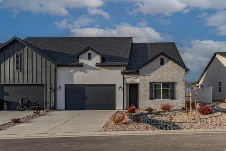 Contemporary exterior featuring a combination of board and batten siding, stucco, and brick facade