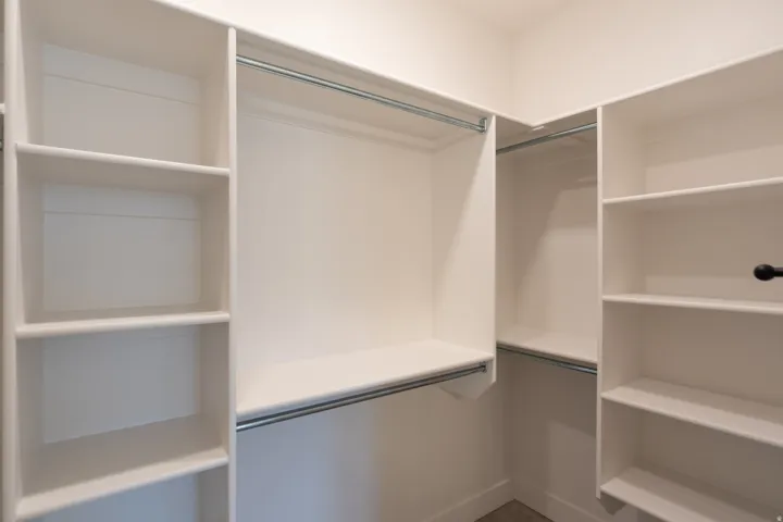 Built-in closet system featuring multiple shelves and hanging rods