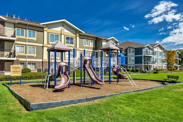 Community playground featuring multiple slides and climbing structures