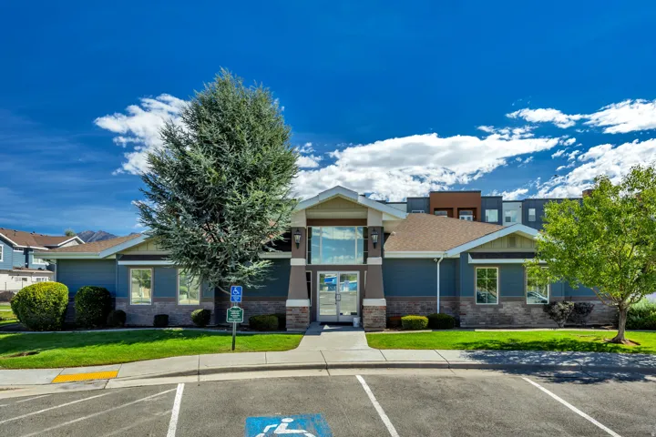 Entry building featuring a stone facade and a prominent glass entryway