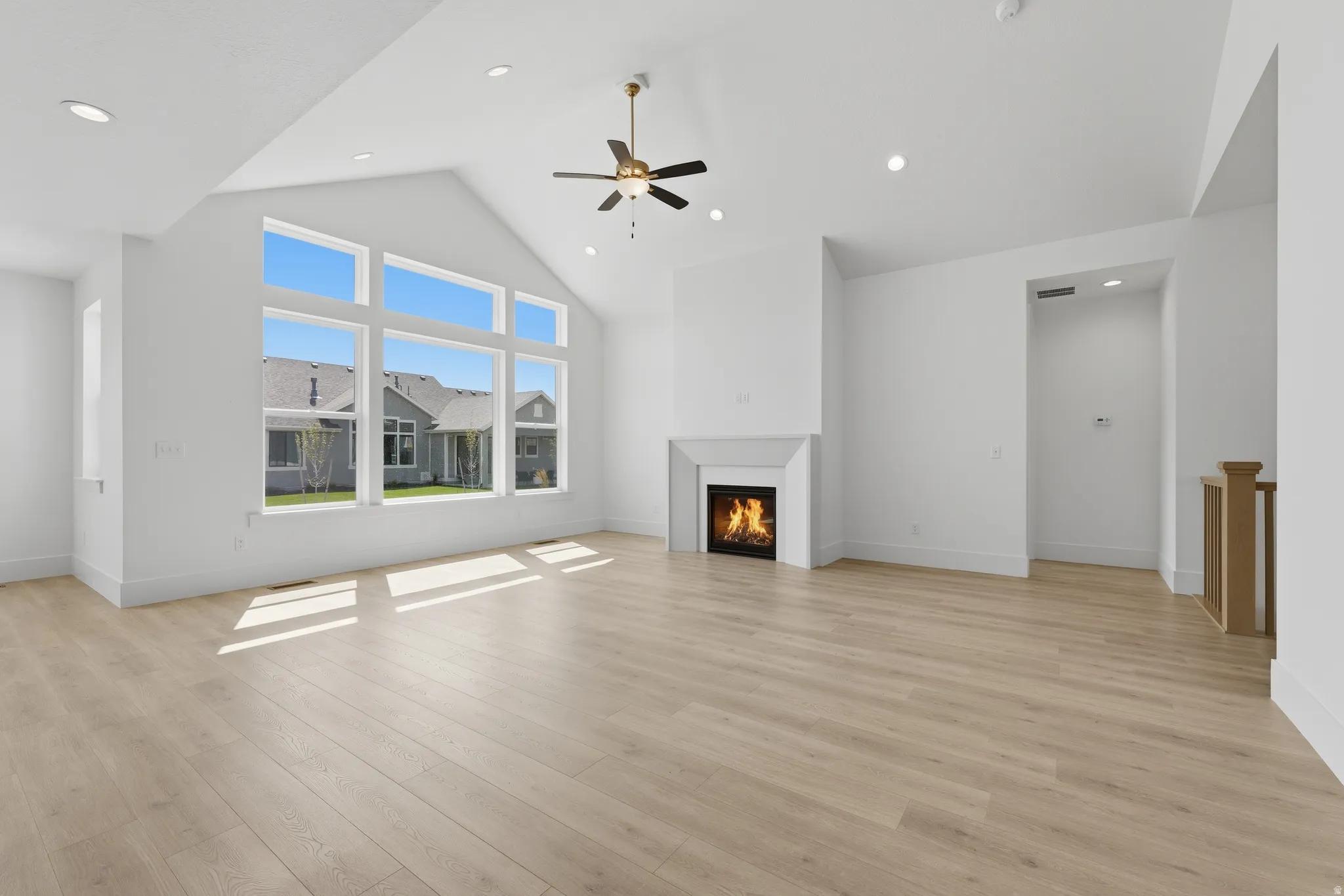 Vaulted ceiling with a ceiling fan and recessed lighting