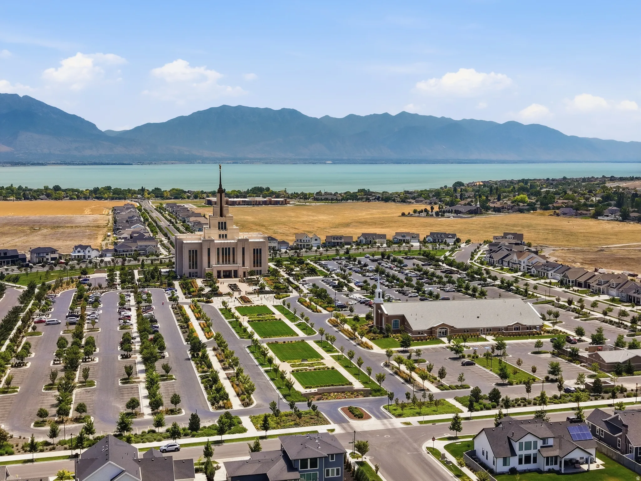 Aerial perspective showcasing a large body of water, distant mountains, and developed residential areas
