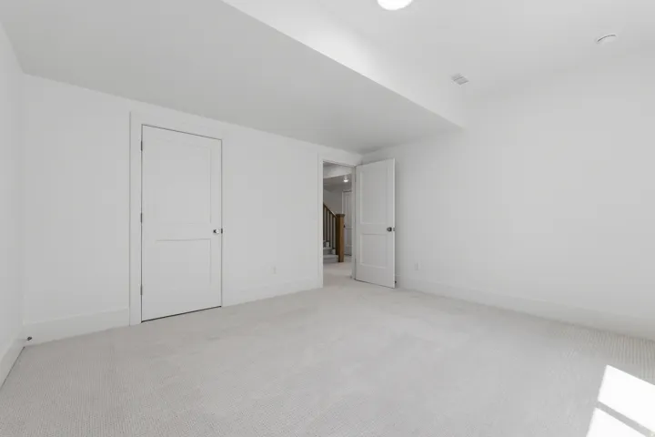 Recessed lighting, light-colored carpet flooring, white walls, and white trim