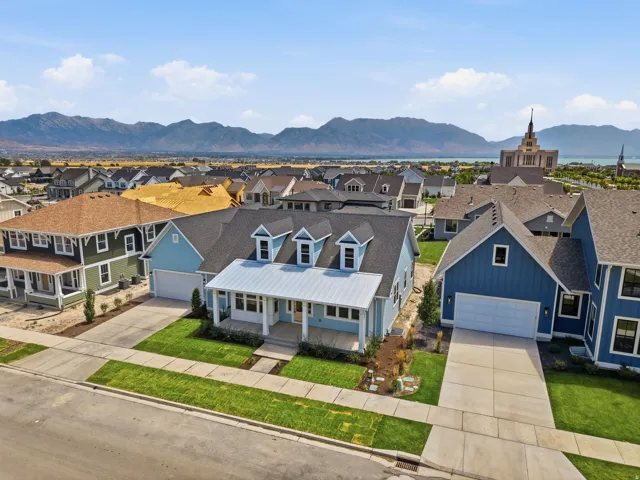 Light blue siding with white trim, a covered porch, and a metal roof accent