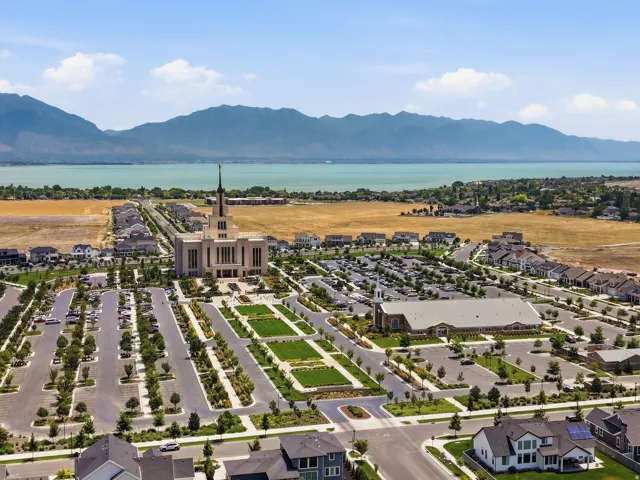 Aerial perspective showcasing a large body of water, distant mountains, and developed residential areas