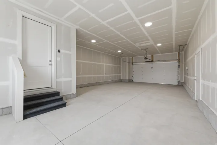 Spacious garage with concrete flooring, recessed lighting, and an automatic garage door opener