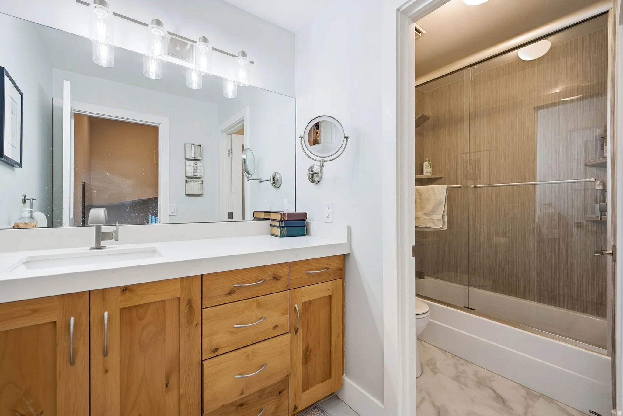 Wood-finish vanity with a white countertop and integrated sink