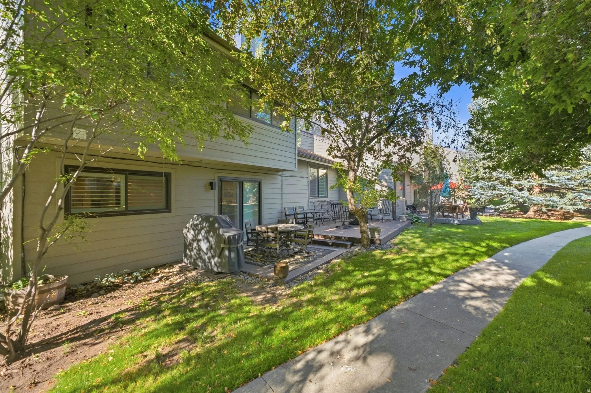 Private outdoor patio with a sliding glass door entry