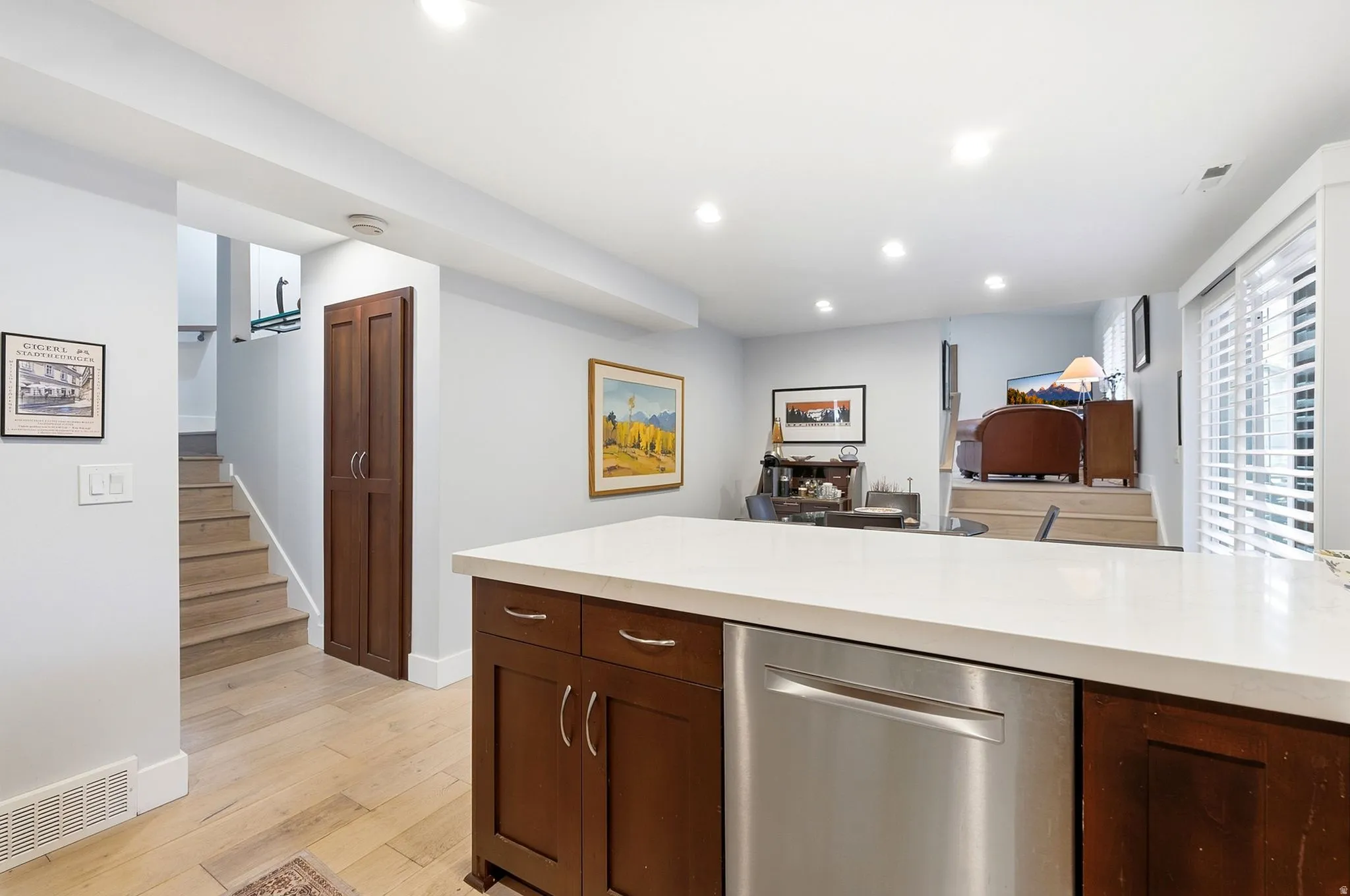Wood-finish flooring, recessed lighting, and a built-in pantry cabinet