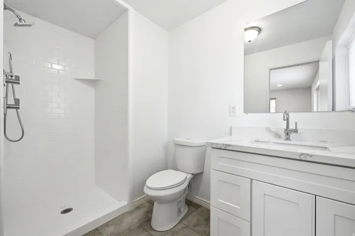 White subway tile shower with a built-in shelf