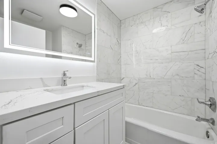 Integrated vanity with undermount sink, quartz countertop, and chrome fixtures