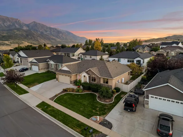 Single-story residence with a two-car garage, concrete driveway, and a landscaped front yard