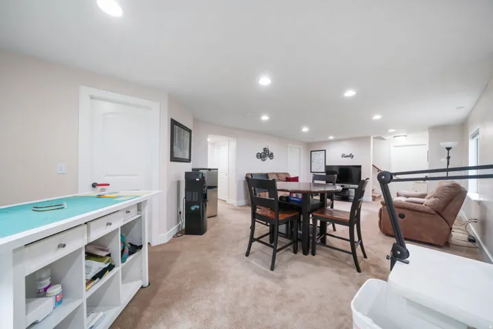 Carpeted floor, recessed lighting, white interior doors, and built-in shelving