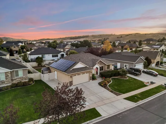 Ranch-style residence featuring a stone and stucco exterior, an attached two-car garage, and a concrete driveway
