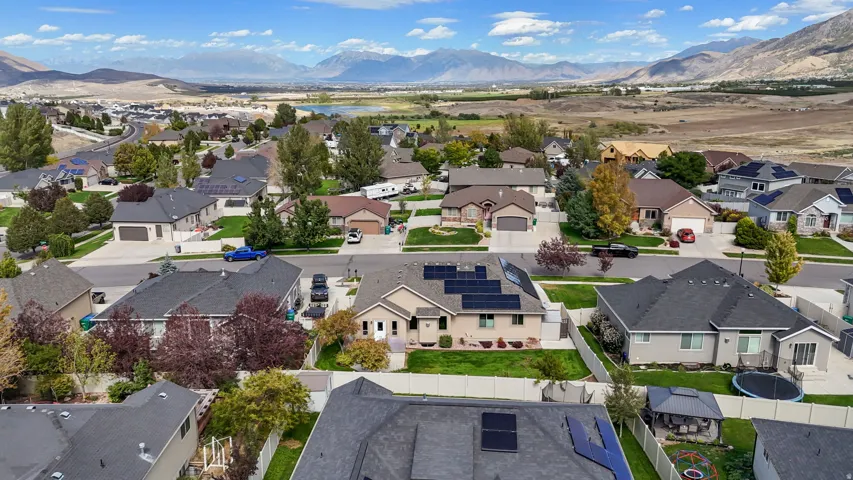 Residential neighborhood with established homes and landscaped yards, set against a backdrop of distant mountains