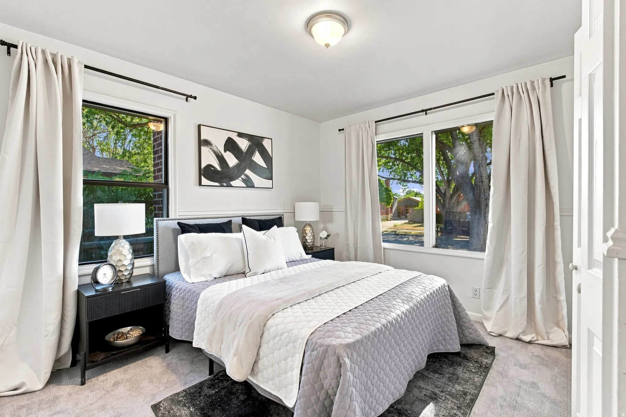 White walls with decorative paneling and neutral carpet