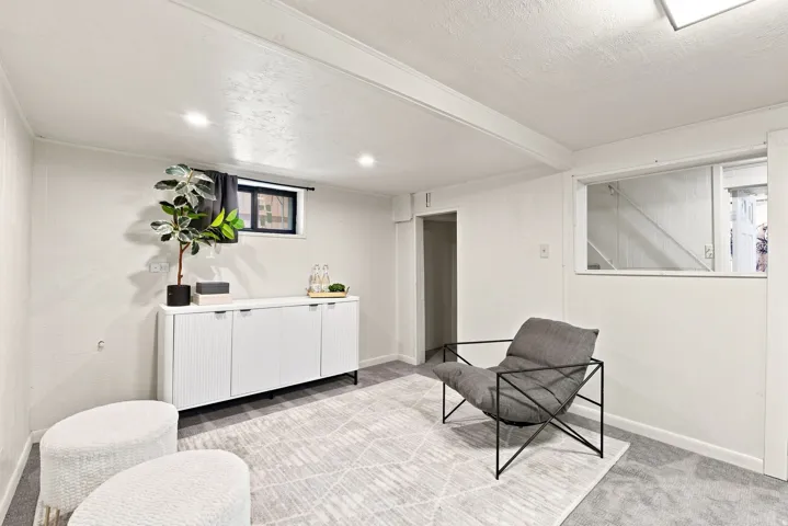 Recessed lighting, exposed ceiling beams, and a built-in window opening