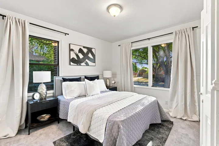 White walls with decorative paneling and neutral carpet