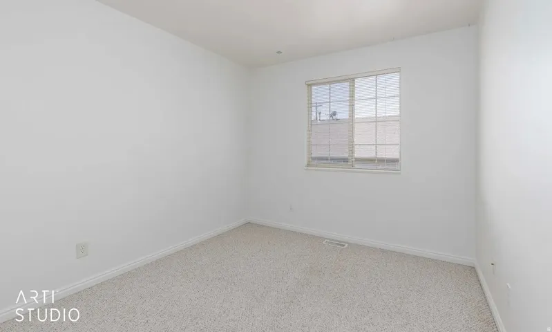 Neutral-toned carpeting with white wall paint
