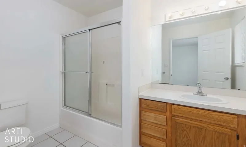 Wood-finish vanity with an integrated sink and chrome faucet