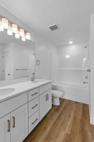Dual vanity with white cabinetry and integrated sinks
