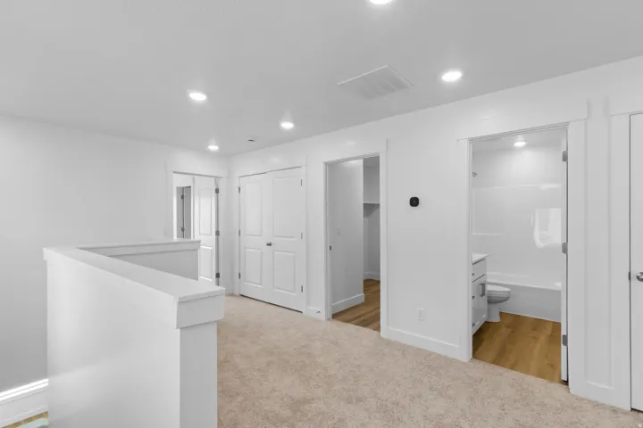 Carpeted interior with recessed lighting, white walls, and white trim
