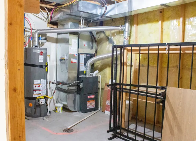 Utility/storage area featuring new water heater and new furnace.