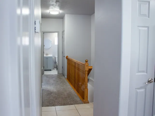 Hallway leading from main living area to bedroom, bathroom, and closet.
