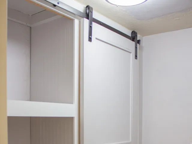 Built-in shelving with sliding panel-style barn door
