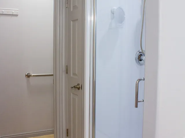 Primary bathroom with new glass-enclosed shower, closet, and separate toilet area