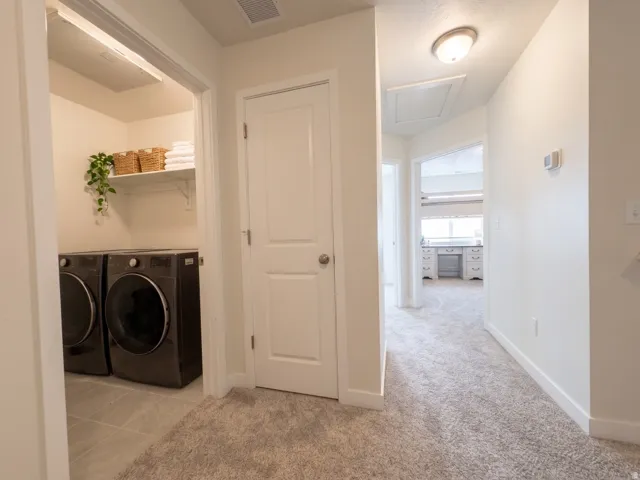 Laundry area with tiled flooring and built-in shelving